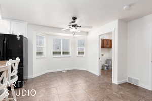 Dining room with a ceiling fan and light tile patterned flooring