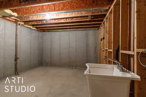 Storage room in basement with a sink