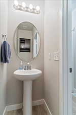 Bathroom with baseboards and wood finished floors