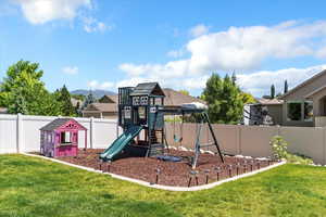 View of jungle gym with a fenced backyard and a mountain view