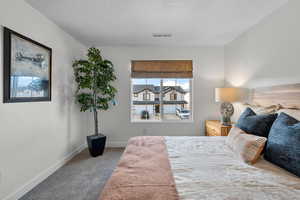 Carpeted bedroom with baseboards