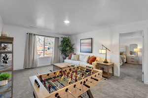Recreation room featuring carpet flooring and baseboards