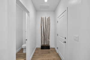 Doorway featuring wood finished floors and recessed lighting
