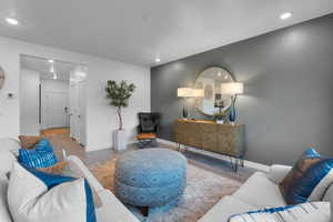 Living area featuring wood finished floors and recessed lighting