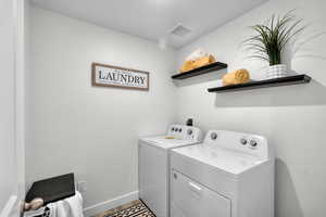 Laundry room featuring independent washer and dryer and wood finished floors