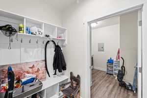 Mudroom featuring wood finished floors and electric panel