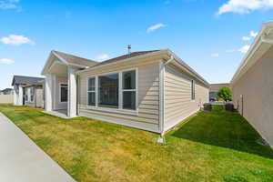 View of side of home featuring a yard