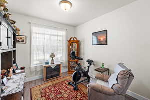 Bedroom featuring wood finished floors and baseboards