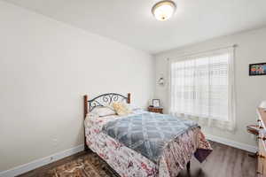 Bedroom with baseboards and wood finished floors