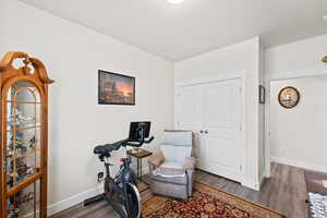 Bedroom with wood finished floors and baseboards