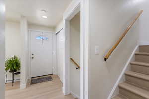 Entrance foyer with light wood-type flooring and baseboards