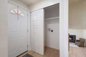 Laundry room with washer hookup and light wood-type flooring