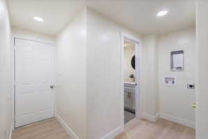 Hallway featuring light wood-type flooring and recessed lighting