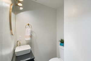 Half bathroom with toilet and vanity