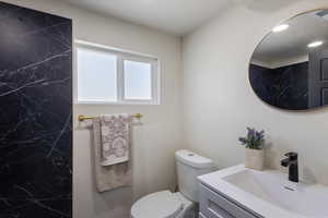 Bathroom featuring vanity and toilet