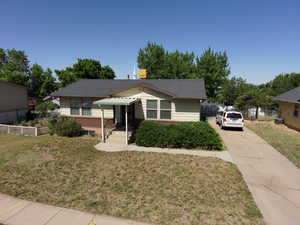 Bungalow featuring brick siding and driveway