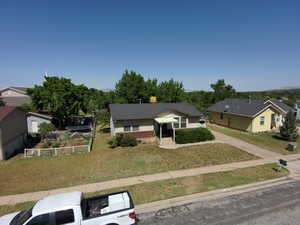 View of front of house with a front lawn and a residential view