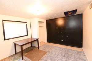 Hallway featuring a textured ceiling