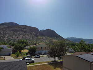 View of mountain backdrop featuring nearby suburban area