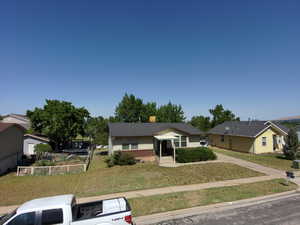 View of front of house featuring a front yard and crawl space