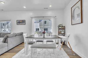 Dining space featuring wood finished floors and recessed lighting