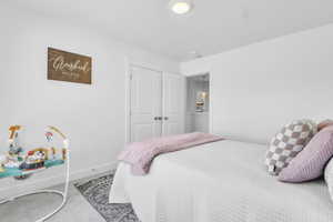 Carpeted bedroom featuring baseboards