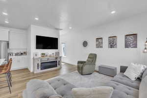 Living room featuring light wood-style floors and recessed lighting