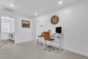 Carpeted office featuring washing machine and clothes dryer and recessed lighting