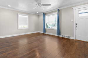 Entryway with ornamental molding, a ceiling fan, recessed lighting, and hardwood / wood-style flooring