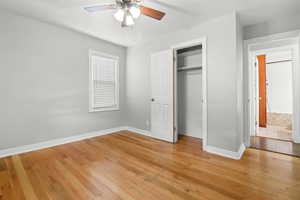 Unfurnished bedroom with light wood finished floors, a closet, and ceiling fan