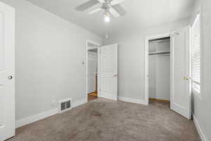 Unfurnished bedroom featuring carpet, a closet, and ceiling fan