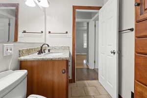 Bathroom with tile patterned floors and vanity