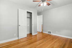 Unfurnished bedroom with light wood-style flooring, a closet, and ceiling fan