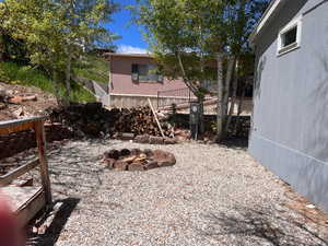 View of yard with an outdoor fire pit