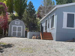 View of property exterior with a storage shed