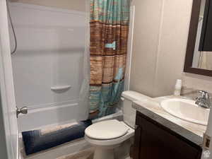 Bathroom featuring shower / tub combo and vanity