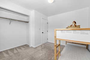 Bedroom with carpet flooring and baseboards