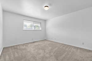 Bedroom with carpet floors and baseboards
