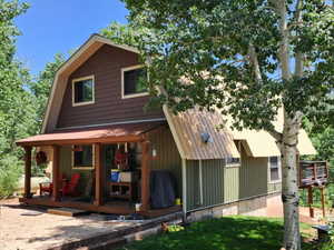 Back of house with a lawn