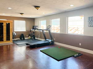 Workout room with a textured ceiling and recessed lighting