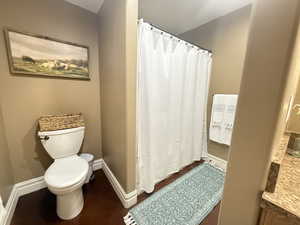 Full bath with toilet and curtained shower