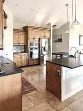 Kitchen with appliances with stainless steel finishes, dark countertops, tasteful backsplash, pendant lighting, and recessed lighting