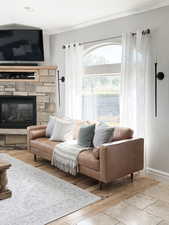 Living room featuring a stone fireplace and wood finished floors