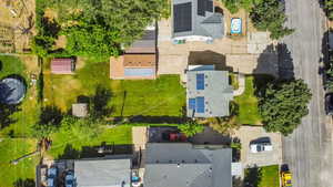 Drone / aerial view of solar panels and backyard