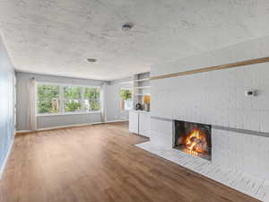 Unfurnished living room with a fireplace and light wood finished floors