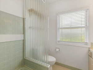Bathroom featuring vanity, plenty of natural light, and shower / bath combination
