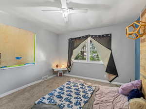 Bedroom with carpet floors and a ceiling fan