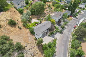 Aerial view of property and surrounding area featuring nearby suburban area