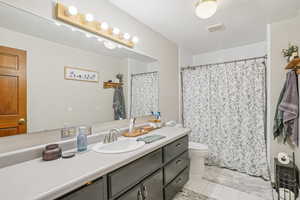 MIL - Bathroom with tile patterned flooring, vanity, and a shower with shower curtain