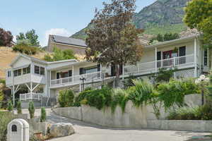 View of property featuring a mountain view and driveway